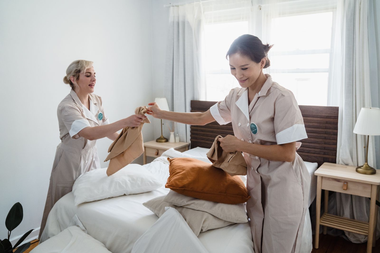 Two housekeepers making a bed
